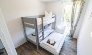 a small room with a bunk bed and a window at Black Forest Hotel Kappel-Grafenhausen in Kappel-Grafenhausen