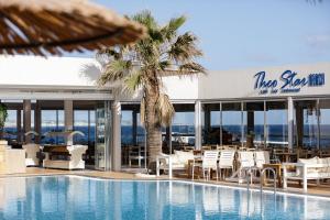 a resort with a swimming pool and a restaurant at Theo Star Beach Hotel in Malia