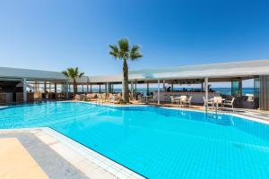 a large swimming pool with a view of the ocean at Theo Star Beach Hotel in Malia