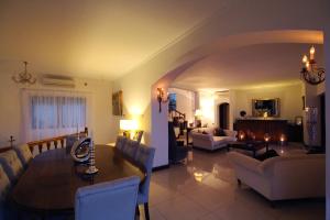 a living room with a table and a dining room at Petit Amour Villa, Seychelles in Victoria