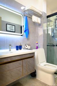 ein Badezimmer mit einem WC, einem Waschbecken und einem Spiegel in der Unterkunft Elite Luxury Apartments Kilimani - A 2 Bedroom Oasis of Serenity in Nairobi