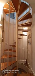 a spiral staircase in a room with a stair case at Ker Karantez in Rennes