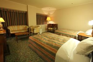 A bed or beds in a room at Hirosaki Park Hotel