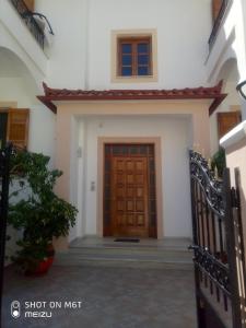 une porte d'entrée d'une maison avec une porte en bois dans l'établissement Delicatessen house, à Leonidio