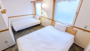 Cama ou camas em um quarto em Toyoko Inn Tokyo Korakuen Bunkyokuyakusho Mae