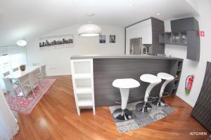 a kitchen with a counter and some stools in a room at Luxury Marina View Apartment Izola in Izola