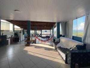 a living room with a couch and a hammock at Pé nas trilhas in Rio de Janeiro