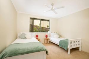 a bedroom with two beds and a window at Villa Franco Pet Friendly 10 Mins Walk to Beach in Surf Beach