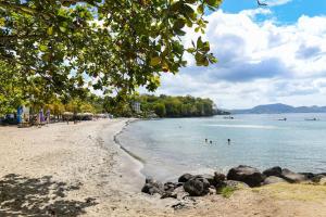 a beach with people swimming in the water at 972D6 - Kaymit - Studio 20m2 in Schœlcher