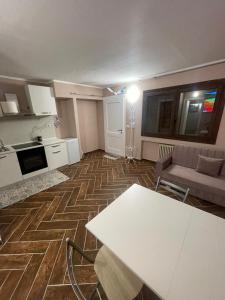 a living room with a white table and a couch at Grange chic in Sestriere