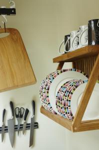 a plate and utensils are hanging on a wall at Hang Your Hat in Winchester