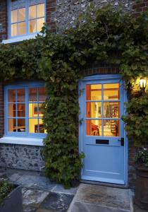 a house with a white door and ivy at Hang Your Hat in Winchester