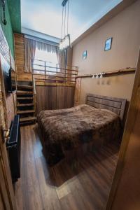 a bedroom with a large bed and a staircase at Evdo Apartments Loft2 Wooden House in Gudauri