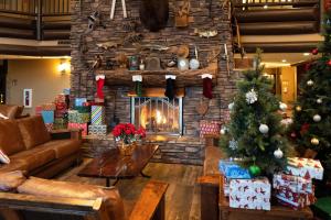 a living room with a christmas tree and a fireplace at The Grand Hotel at the Grand Canyon in Tusayan