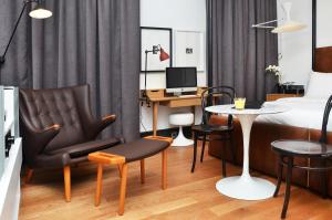 a bedroom with a bed and a desk and a chair and a table at Browns Boutique Hotel in Lisbon