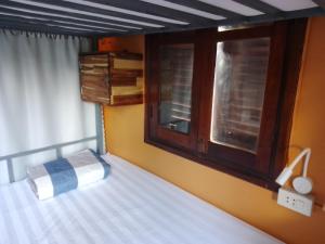 1 dormitorio con cama y ventana en Funny Riverside Backpackers, en Luang Prabang