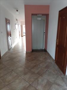 an empty hallway with a tile floor and a door at WynajemPokoi-StołówkaGerlachscŁętowskiWłŁętowskaM ŁętowskaL Łętowska-HyłaB in Białka Tatrzanska