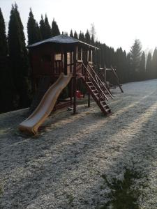 a playground with a slide in the middle of a field at WynajemPokoi-StołówkaGerlachscŁętowskiWłŁętowskaM ŁętowskaL Łętowska-HyłaB in Białka Tatrzanska