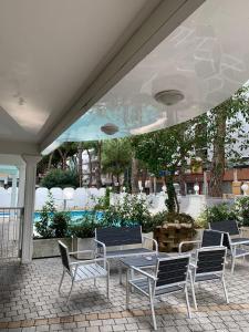 a group of chairs and a table on a patio at Hotel Royal Plaza in Rimini