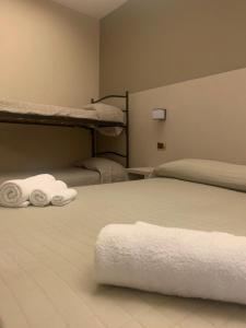 a bedroom with two bunk beds with towels at Hotel Royal Plaza in Rimini