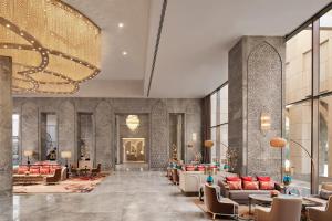 a lobby with couches and tables and a chandelier at Taj Amer, Jaipur in Jaipur