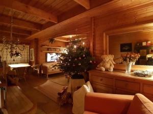 - un salon avec un arbre de Noël dans une cabine dans l'établissement Mont Blanc Chalet, à Grandevent