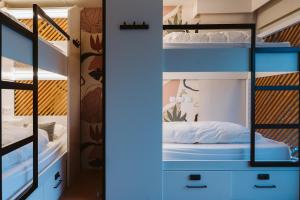 A bed or beds in a room at The Salty Pelican Yoga & Surf Retreat