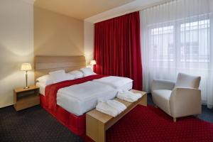 A bed or beds in a room at Imperial Hotel Ostrava