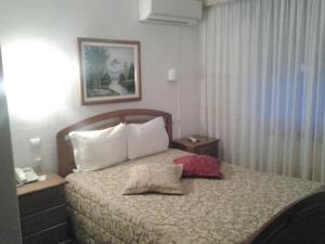 A bed or beds in a room at Residencial Pinto