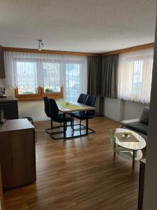 a living room with a table and chairs and a couch at Haus Castello in Saas-Almagell