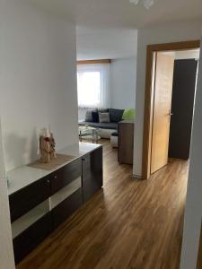 a living room with a couch and a wooden floor at Haus Castello in Saas-Almagell