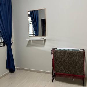 a mirror and a bed in a room with a window at Homestay Ayer Keroh Tasik Utama in Ayer Keroh