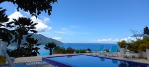 a swimming pool with a view of the ocean at Petit Amour Villa, Seychelles in Victoria