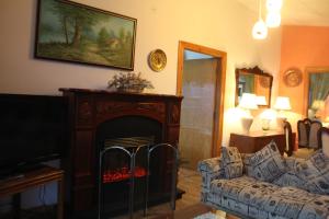 a living room with a couch and a fireplace at European Complex in Bhurban