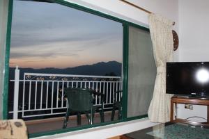 a room with a large window with a view of the ocean at European Complex in Bhurban