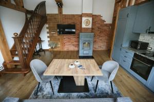 a kitchen with a table and chairs and a staircase at Nora Berry in Nida