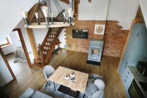 an overhead view of a living room with a table and a fireplace at Nora Berry in Nida