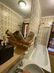 a bathroom with a sink and a bath tub at Skyline su Sestriere in Sestriere