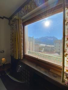 a window with a view of a mountain view at Skyline su Sestriere in Sestriere