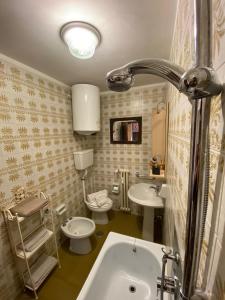 a bathroom with two toilets and a sink at Skyline su Sestriere in Sestriere