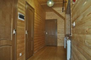 a hallway with wood paneled walls and a door at Proskurov Holiday Home in Bukovel