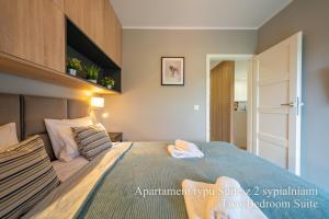 Katil atau katil-katil dalam bilik di RentPlanet - Apartamenty IzerSKI Resort