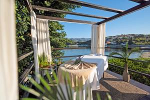 a table on a balcony with a view of the water at TUI BLUE Kalamota Island - Adults Only in Dubrovnik