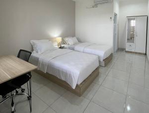 Tempat tidur dalam kamar di 9 Residence Guesthouse Syariah Cilandak