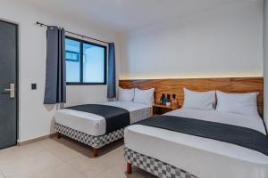 Ένα ή περισσότερα κρεβάτια σε δωμάτιο στο Hotel Mody Merida