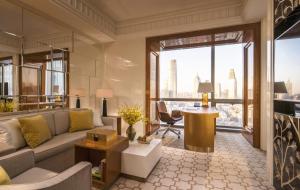 a living room with a couch and a desk in a building at Four Seasons Hotel Tianjin in Tianjin