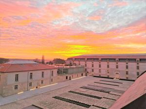 a sunset view from the roof of a building at Résidence de l'Arsenal Royal - Meublés de Tourisme in Rochefort