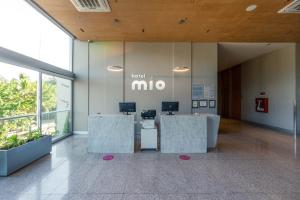 プエルト・バジャルタにあるHotel Mio Vallarta Unique & Different- Adults Onlyの机二つ、壁に見事な看板