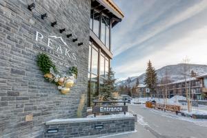 a building with a sign on the side of it at Peaks Hotel and Suites in Banff