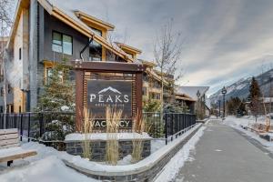 a sign in front of a lodge in the snow at Peaks Hotel and Suites in Banff